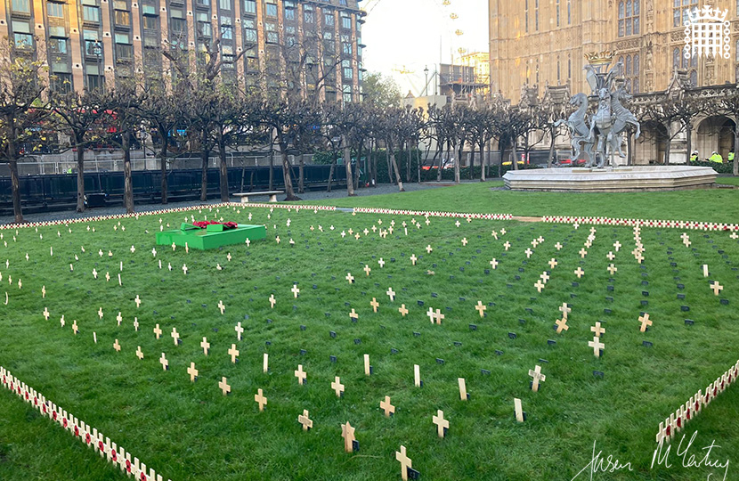 Jason McCartney MP places a Remembrance cross in the Constituency Garden of Remembrance at the Palace of Westminster