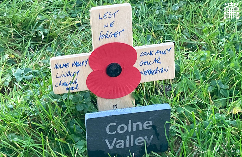 Jason McCartney MP places a Remembrance cross in the Constituency Garden of Remembrance at the Palace of Westminster